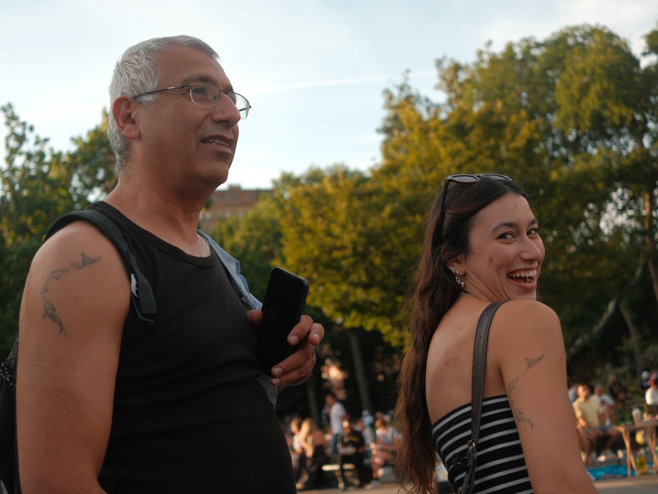 A father and daughter sharing a laugh in the park.